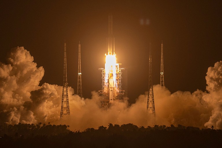 A rocket takes off amid clouds of vapour.