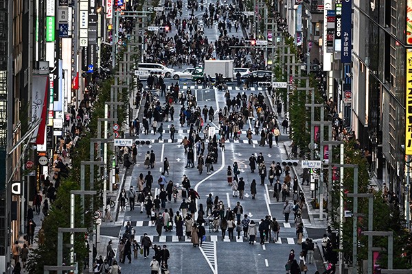 People walk on a street in Tokyo on 22 November 2020.