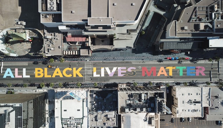 Overhead view of the words "All Black Lives Matter" painted on a road