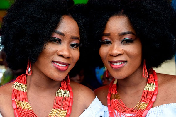 Identical twin sisters Kehinde Olofin (L) and Taye Olofin (R) attends Igbo-Ora World Twins festival