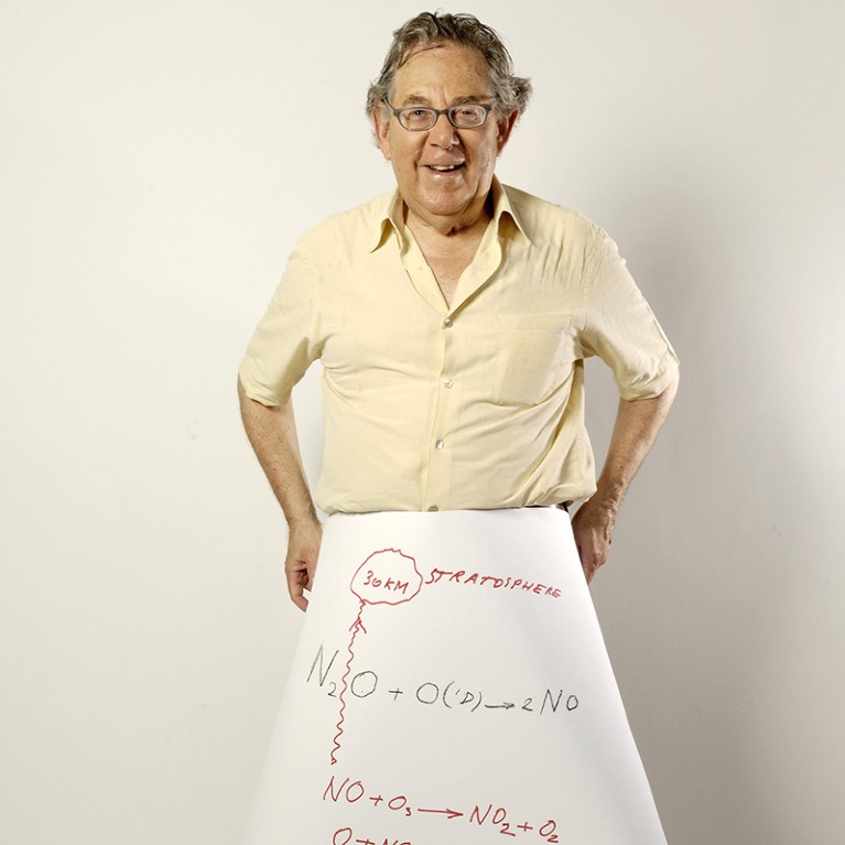 Paul J. Crutzen holding a sheet showing the reaction of nitrogen oxides with ozone