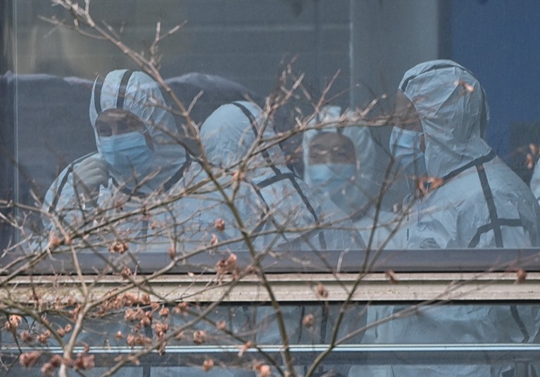 Members of the WHO team in protective gear.