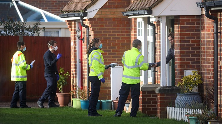 Emergency services workers go door-to-door handing out Covid-19 testing kits in the UK
