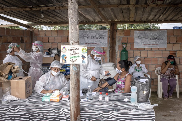 Indigenous healthcare workers wearing PPE treat patients for the coronavirus in Manaus, Brazil
