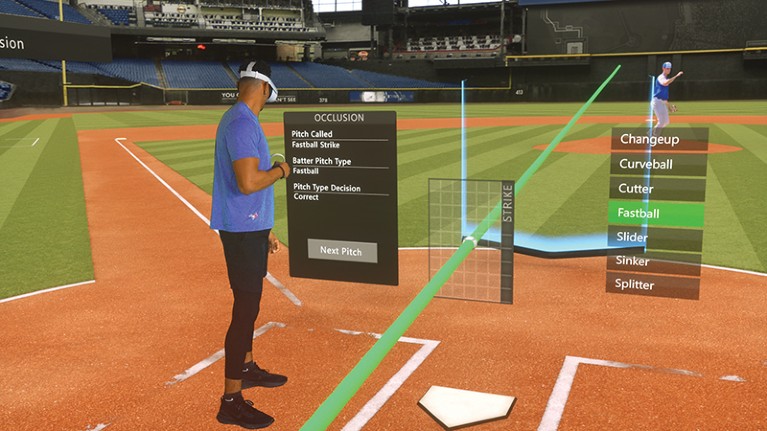 A man stands on a virtual baseball pitch