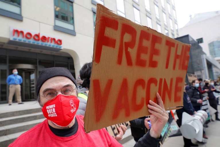 Demonstrators take part in a protest outside the headquarters of Moderna Therapeutics