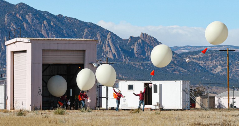 Series of superimposed pictures of a person releasing a large white balloon, with mountains in the background.