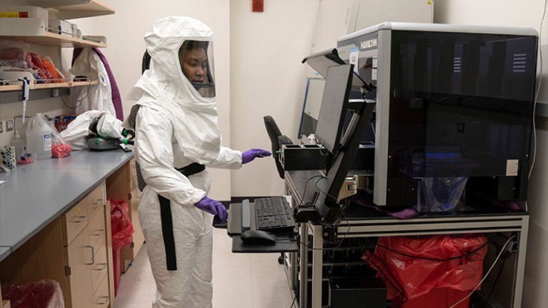 A lab assistant works on positive COVID tests for sequencing at the University of Maryland School of Medicine.