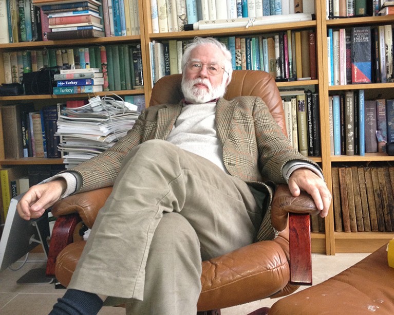 Thomas Cavalier-Smith sitting in his library in 2012