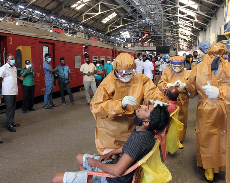Health workers conduct COVID tests on workers at the Fort Railway Station in Sri Lanka's capital Colombo