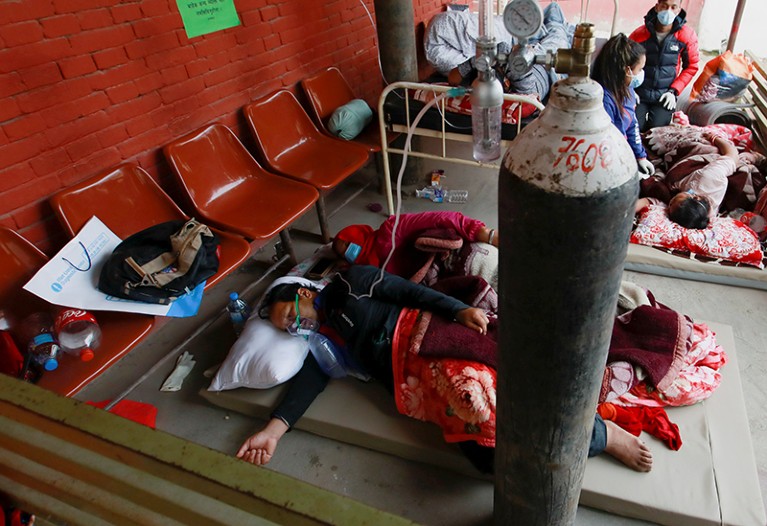 Patients receive oxygen as they sleep on the floor outside hospital due to overcrowding from COVID