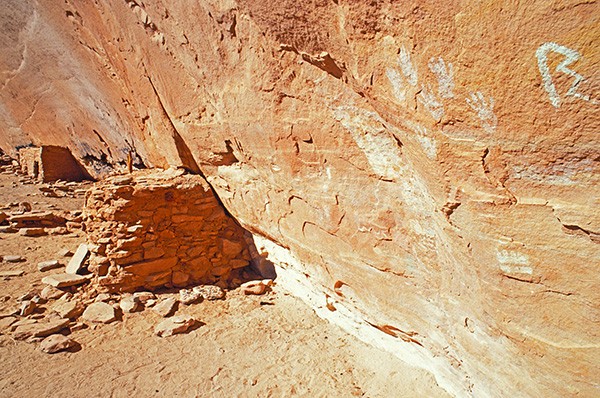 Ancestral Pueblo hand prints and granaries at the Turkey Pen Ruin site in Utah