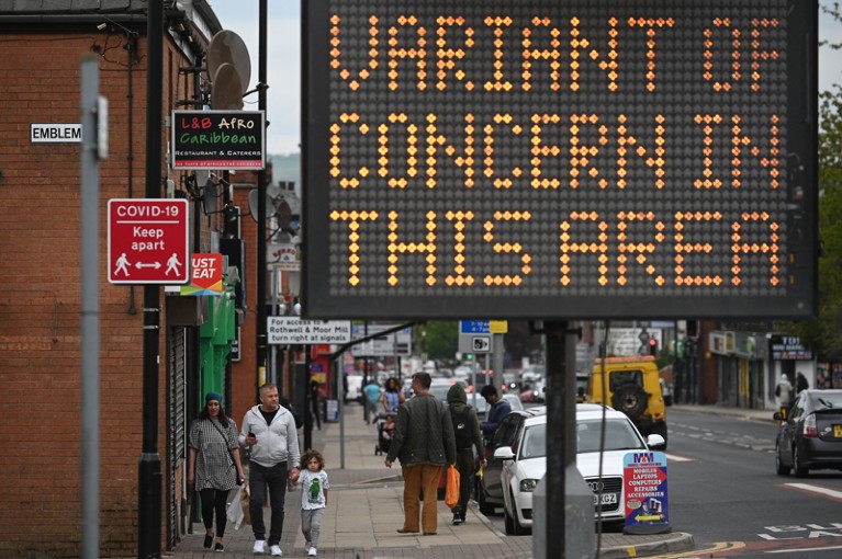 A digital board warns the public of a COVID-19 variant of concern affecting the community.