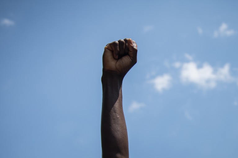 A man raises his fist during a demonstration for black lives matter