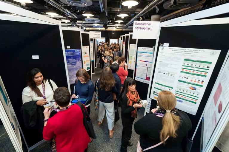 Attendees talk and observe posters during the INORMS 2018 Poster Exhibition