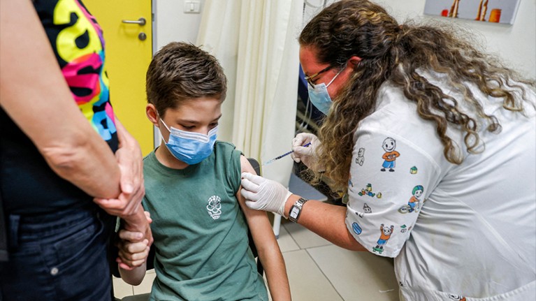 A boy receives a dose of the Pfizer/BioNTech Covid-19 vaccine at the Clalit Healthcare Services in the Israeli city of Holon.
