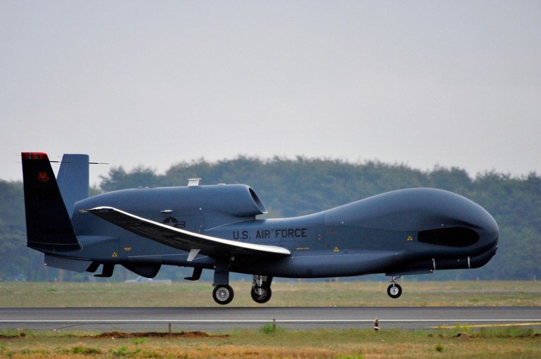 A US Air Force RQ-4 Global Hawk unmanned aerial drone lands on a runway