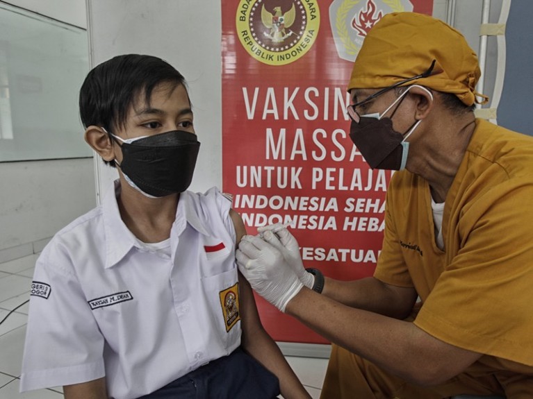 A student receives the Sinovac Covid-19 vaccine, Indonesia.