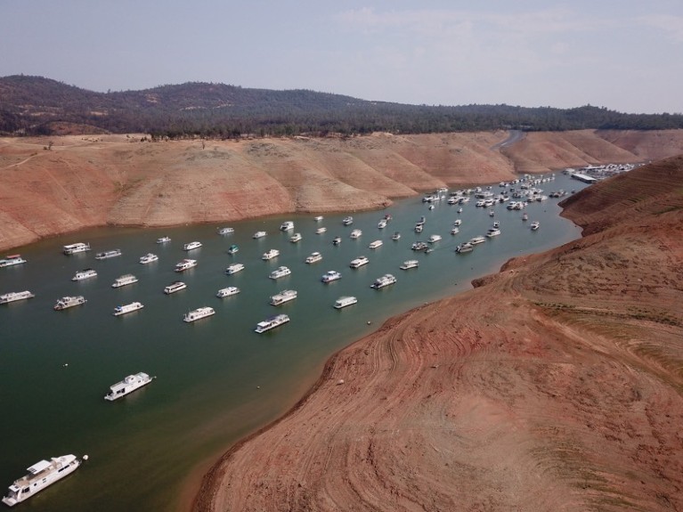 In this aerial photo houseboats sit in low water on Lake Oroville as California's drought emergency worsens.
