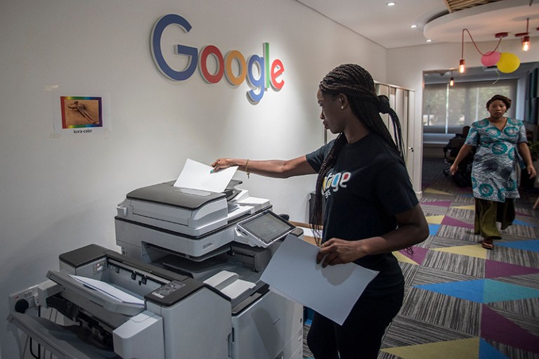 A woman makes copies at the Google Artificial Intelligence centre in Accra, Ghana, Africa.
