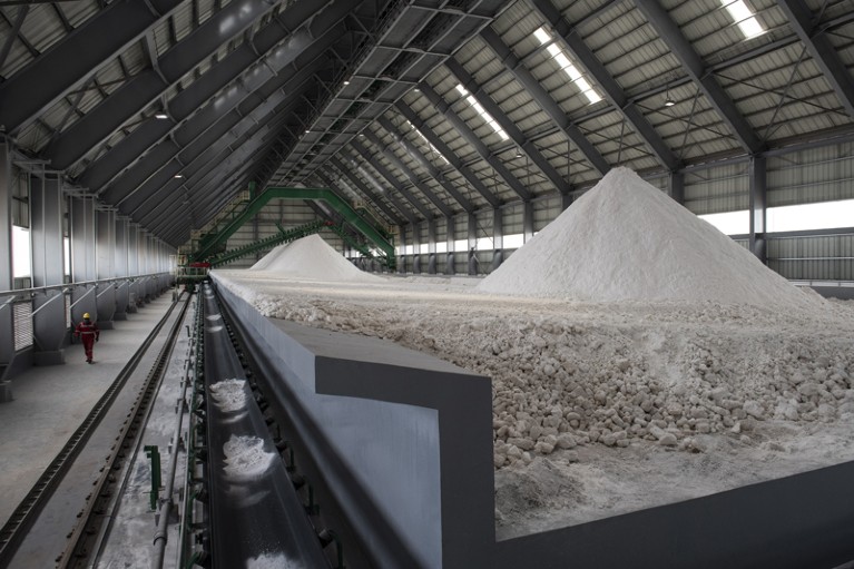 Salt deposits sit in huge piles inside a warehouse at a lithium production facility at the Salar de Uyuni, Bolivia