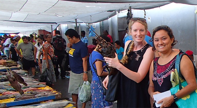 Georgina Gurney and Sangeeta Mangubhai are photographed standing in a fish market in Suva, Fiji