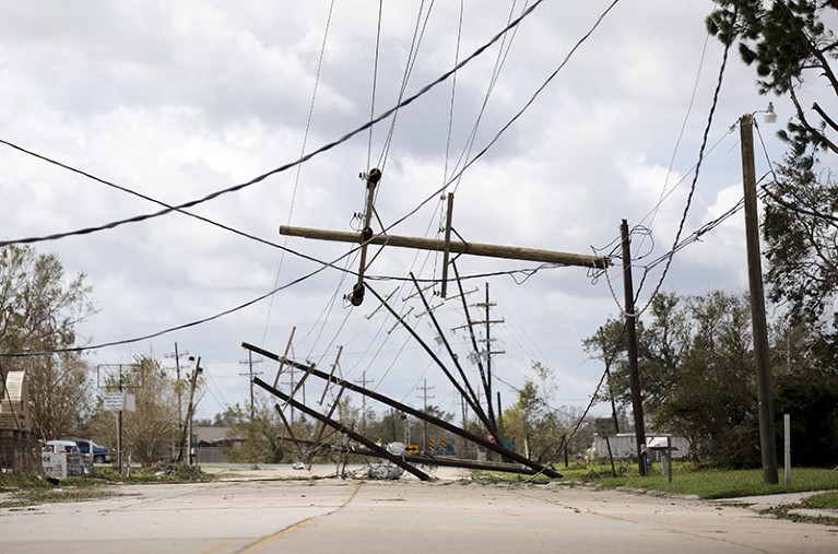 Power-line poles fallen across a street.