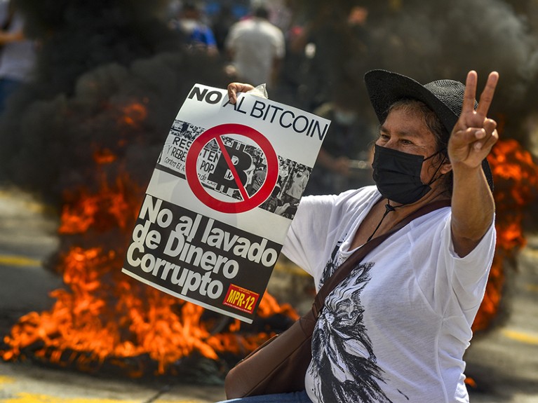 A demonstrator holds a sign during a protest against President Nayib Bukele and bitcoin in El Salvador.