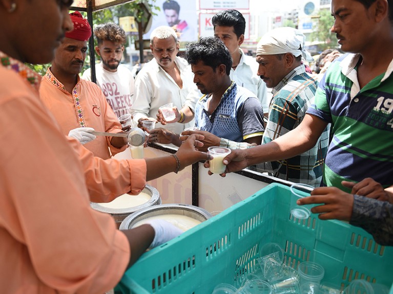People receive glasses of Buttermilk on a hot afternoon in Ahmedabad on 2 June 2019.