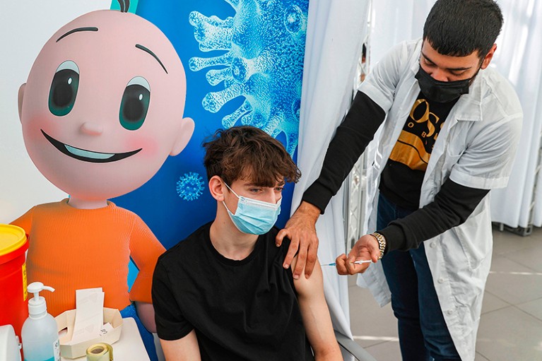 Jonathan, a 16-year-old teenager, receives a dose of the Pfizer-BioNTech COVID-19 vaccine in Tel Aviv.