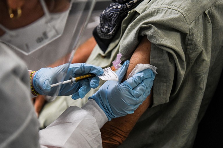 A trial of a COVID-19 vaccination is injected to a patient at the Research Centers of America in Hollywood, Florida in 2020.