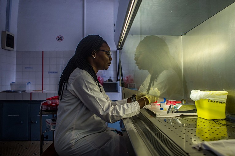 Medical biotechnologist Sandrine Tossu analyses flasks of urine at a hospital in Benin.