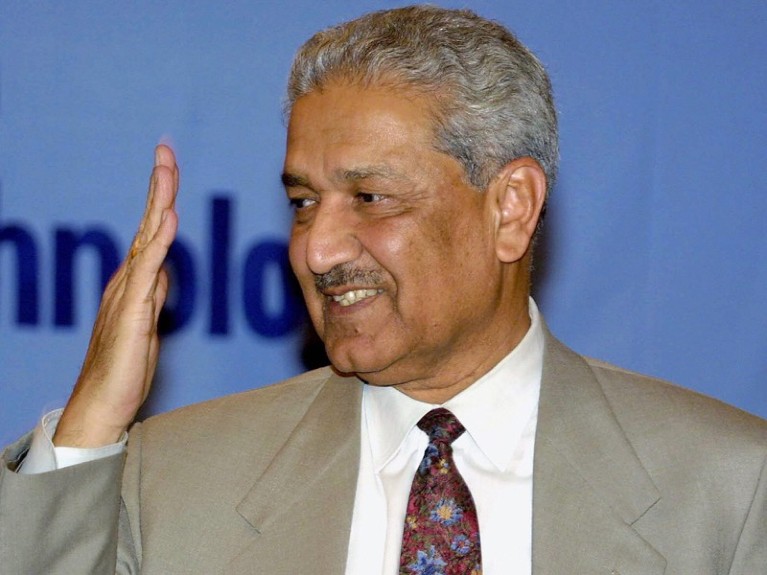 Pakistan's top nuclear scientist Abdul Qadeer Khan salutes the visitors as he arrives at a seminar.
