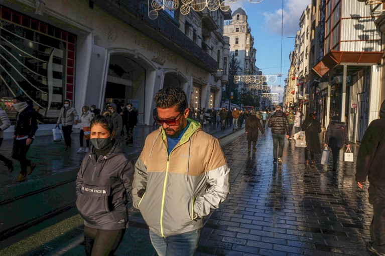 A couple walking on the streets of Beyoglu in the sun