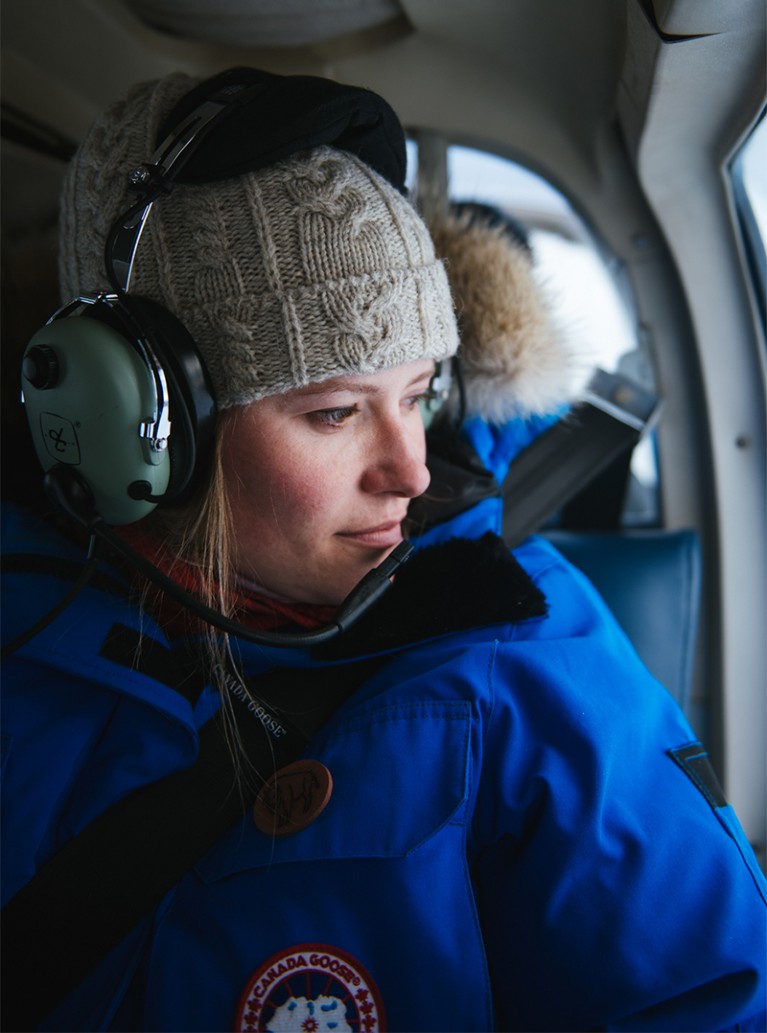 Alysa McCall photographed in a helicopter looking out at the ice.