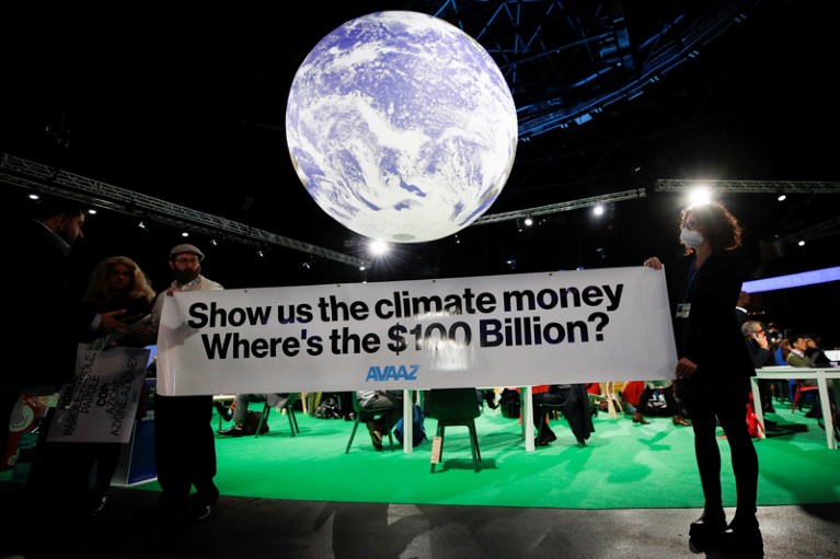 Avaaz activists hold a sign during the UN Climate Change Conference