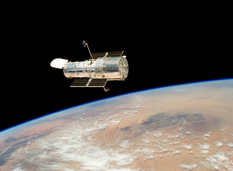 The Hubble Telescope drifts over Earth