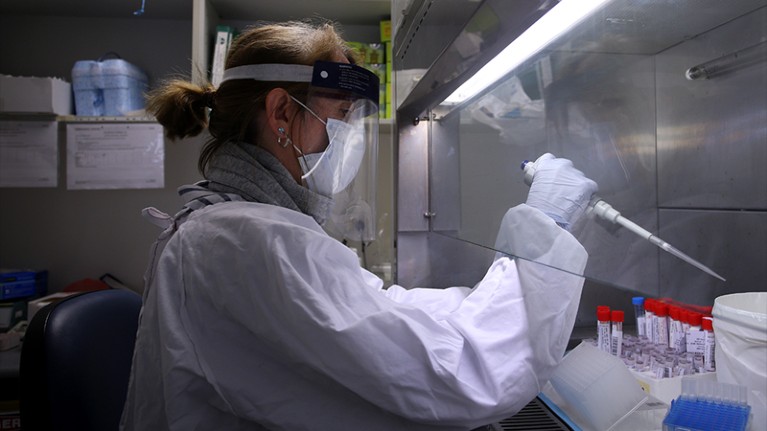 A hospital scientist carries out sample aliquoting of a coronavirus sample.