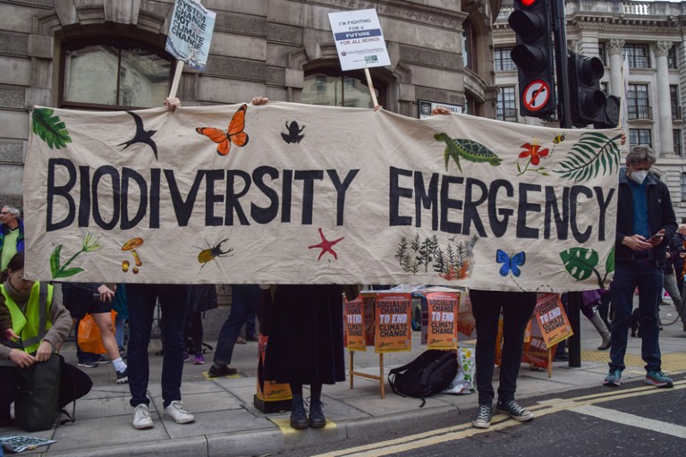 Protesters hold a 'Biodiversity Emergency' banner during the demonstration outside the Bank of England