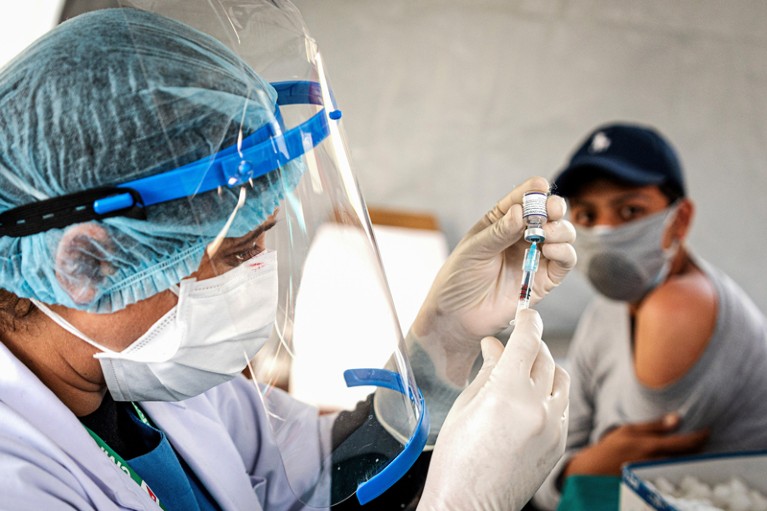 A health worker prepares the Pfizer-BioNTech vaccine at a hospital