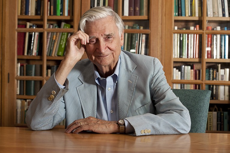 Professor E.O. Wilson in his office, at a table in front of a bookshelf, at Harvard University in Cambridge, Massachusetts, USA.