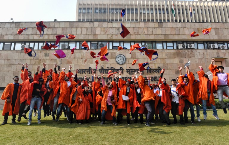 Graduates at the Indian Institute of Technology throwing their caps in the air on campus
