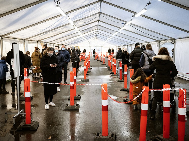 People queue at a Covid-19 polymerase chain reaction (PCR) testing center in Valby, outside Copenhagen, Denmark.