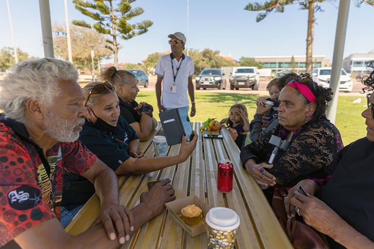 Members of the indigenous community at an outdoor table discuss COVID certificate on January 27, 2022 in Geraldton, Australia.