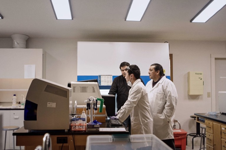 Members of the Native BioData Consortium use a genome sequencer in a lab