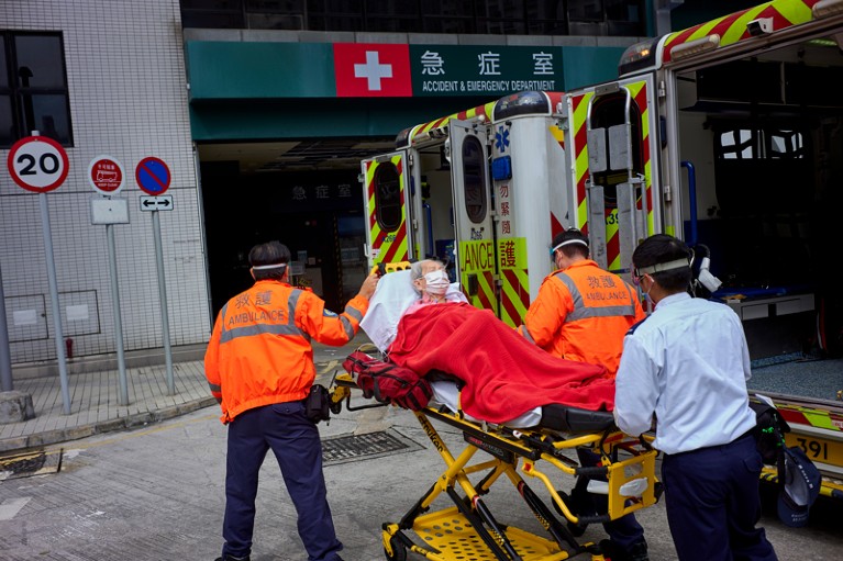 Medical staff transport an elderly person on a medical stretcher to a hospital