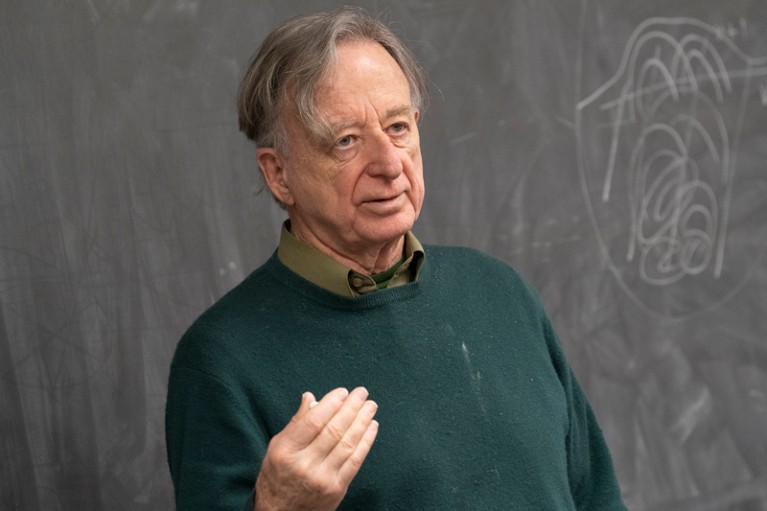John Griffin standing at a black board