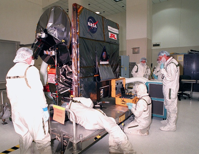 Technicians work on NASA's Mars Climate Orbiter which was launched into space on December 11, 1998.
