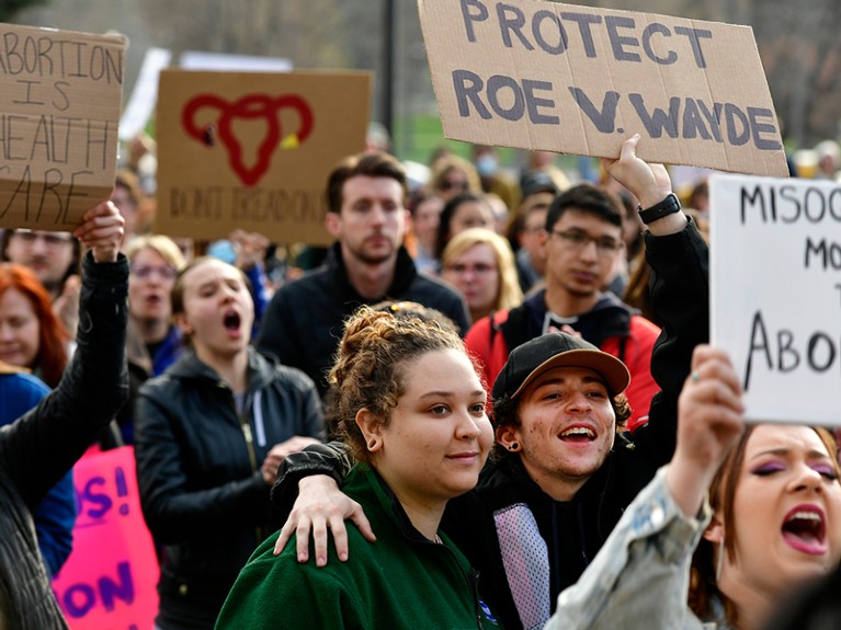 Protesters hold up signs in a rally outside of the Colorado State Capitol against Supreme Court who may overturn Roe V Wade.