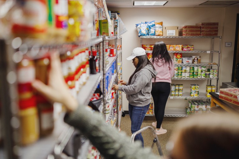Student volunteers and workers stock the shelves and take inventory at a university food bank